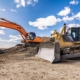 Side view of two excavators at a construction site