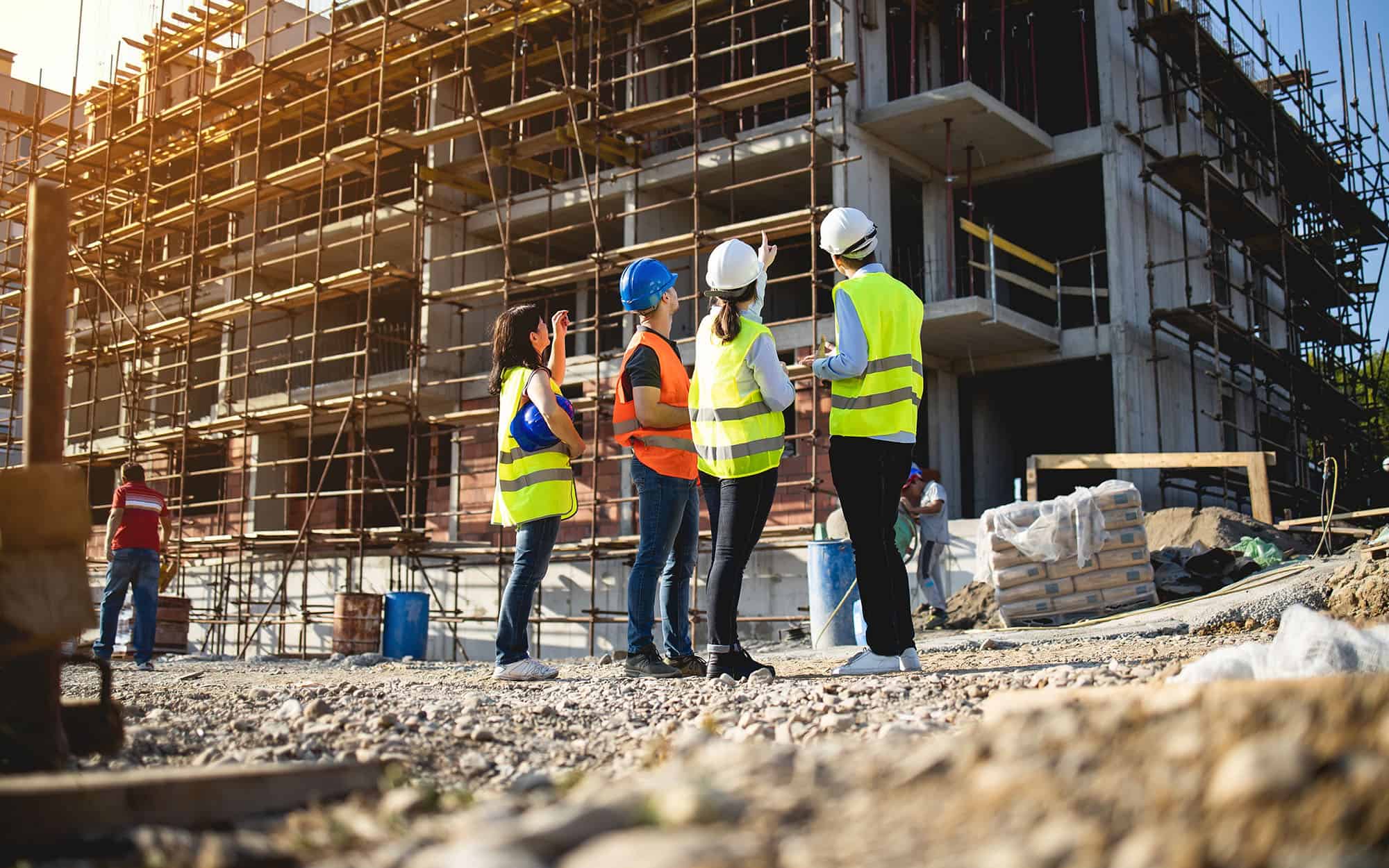 Back view of construction workers having work meeting